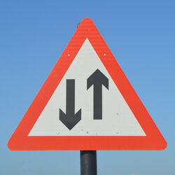 Warning sign with arrows pointing in opposite ways Photo by Paule Knete Unsplash