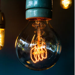 Lightbulb with glowing filament Photo Photo credit Christian Dubovan Unsplash