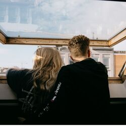Couple looking out of rooftop window photo by sinitta leunen Unsplash