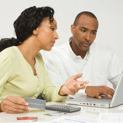 Man and woman reviewing finances on laptop Photo by Thinkstock