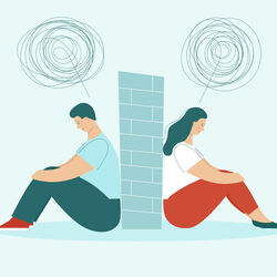 Couple sitting with backs to a wall I Stock 1254958879