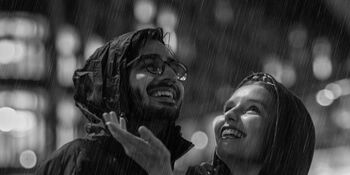 Could in rain and raincoats smiling iStock-867560416
