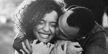 couple holding each other and laughing iStock-1006452986.jpg