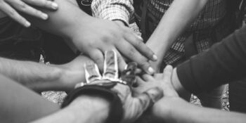 Hands in group community by dio hasbi on pexels