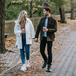 Couple walking and talking in Central Park by Katerina Holmes