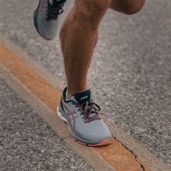 Running shoes on runner showing up by Jakob Owens on Unsplash