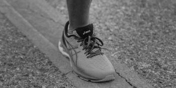 Running shoes on runner showing up by Jakob Owens on Unsplash